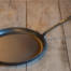 Freshly forged griddle on a wood table