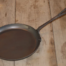 Hand forged griddle on a wood table